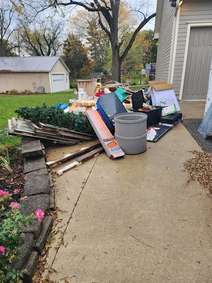Dumpster being loaded with debris for Roofing Dumpster Rental in Johnston